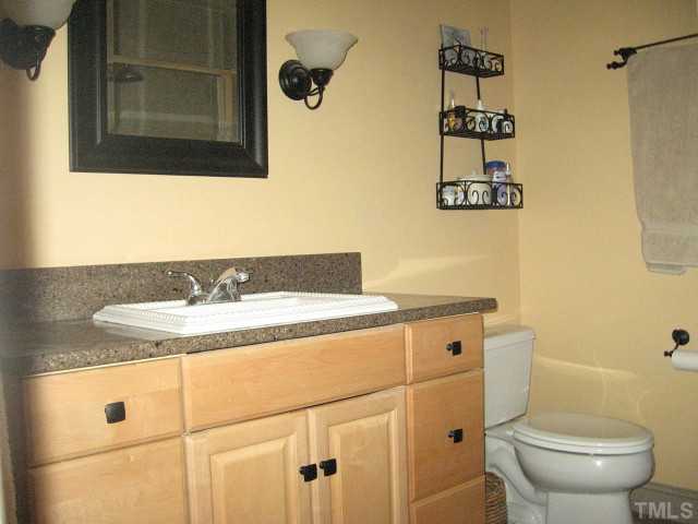 1200 Mindees Court Raleigh, NC 27609 - Photo 6 of 11 a bathroom with a granite countertop sink toilet and mirror