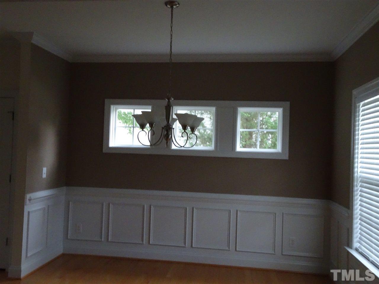 104 West Waycliff Road Henderson, NC 27537 - Photo 5 of 25 The dining room has chairrail and upper windows and beautiful hardwood floor
