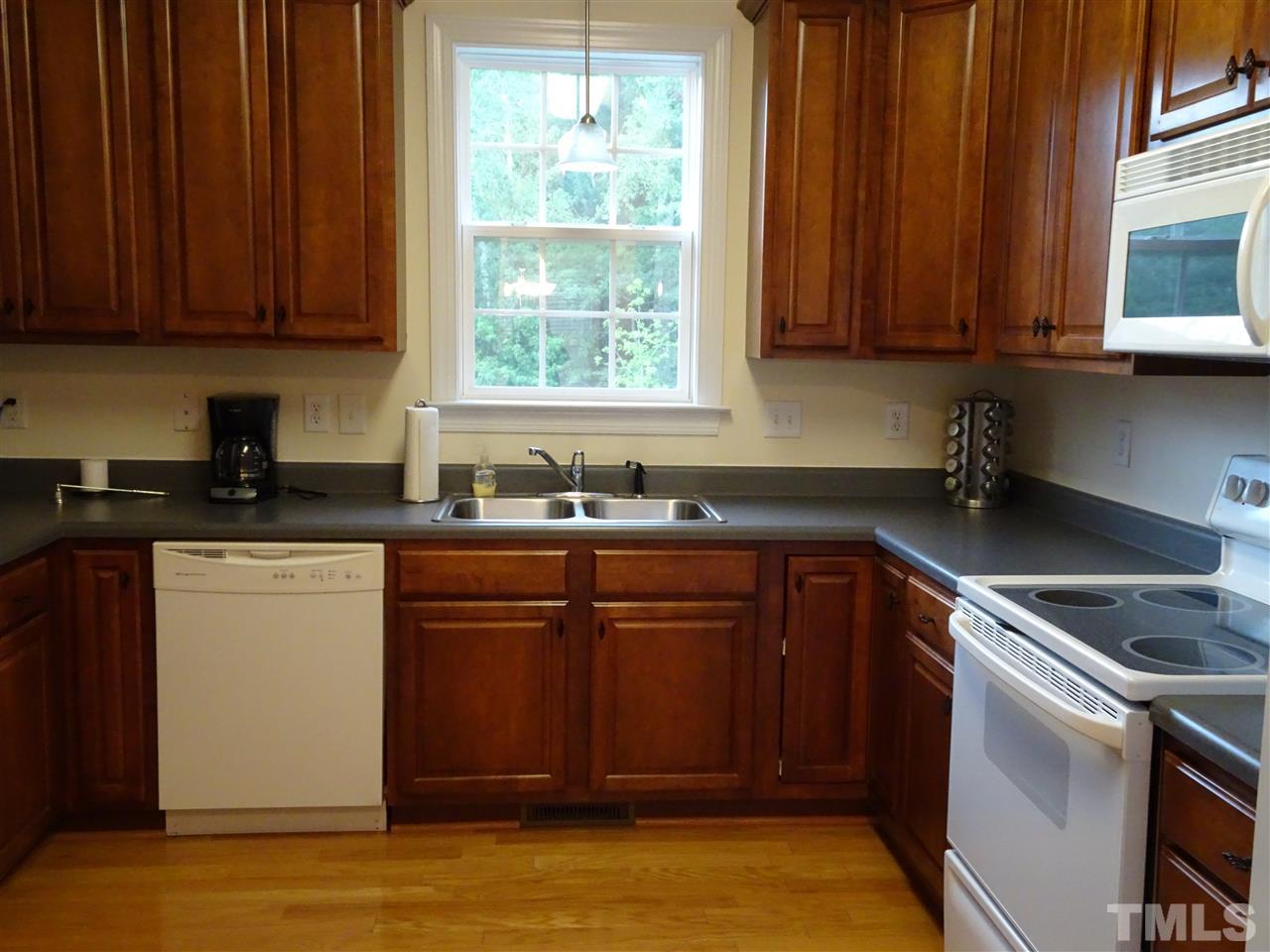 104 West Waycliff Road Henderson, NC 27537 - Photo 6 of 25 The kitchen is equipped with smooth top range, microwave, dishwasher and a 6 year old refrigerator
