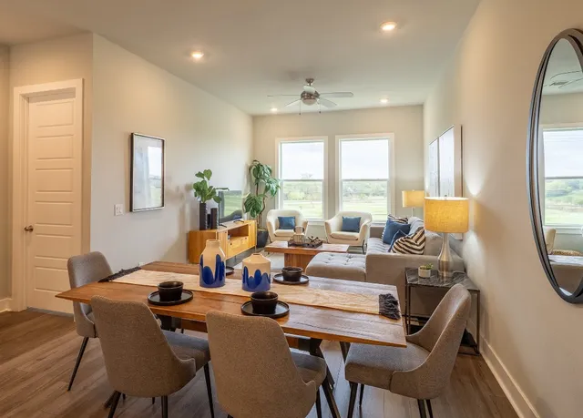 a living room with fireplace furniture and a large window