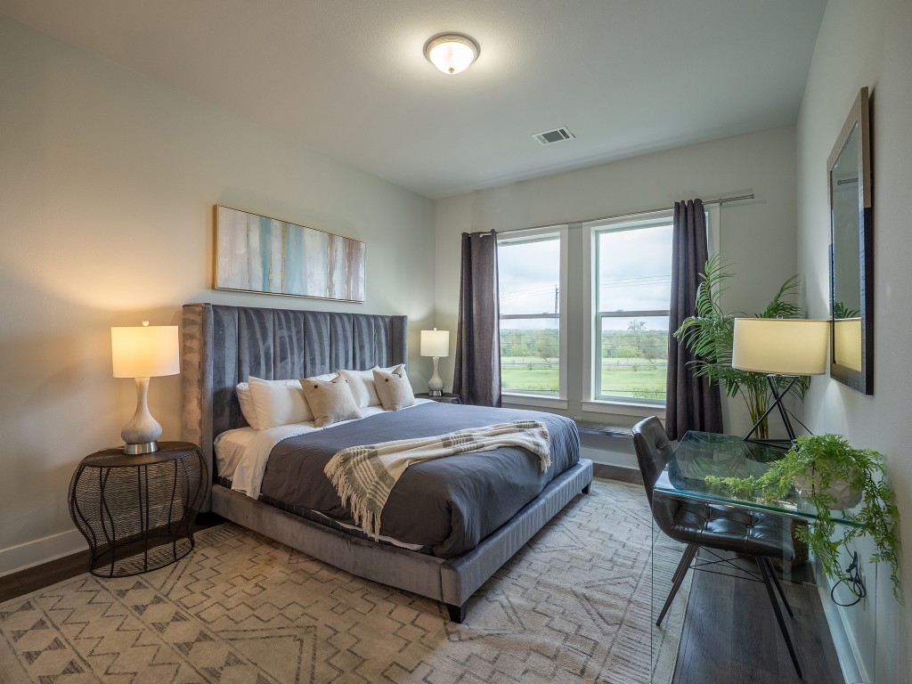 4507 East Martin Luther King Jr Boulevard, Unit 123 Austin, TX 78721 - Photo 11 of 26 Bedroom with baseboards and wood finished floors