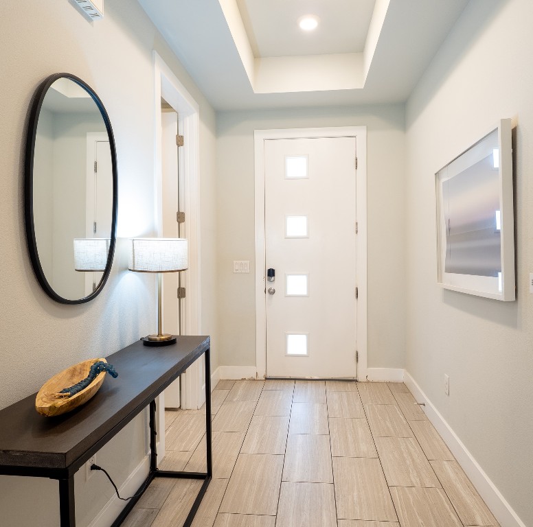 4507 East Martin Luther King Jr Boulevard, Unit 123 Austin, TX 78721 - Photo 19 of 26 Foyer with a raised ceiling and baseboards