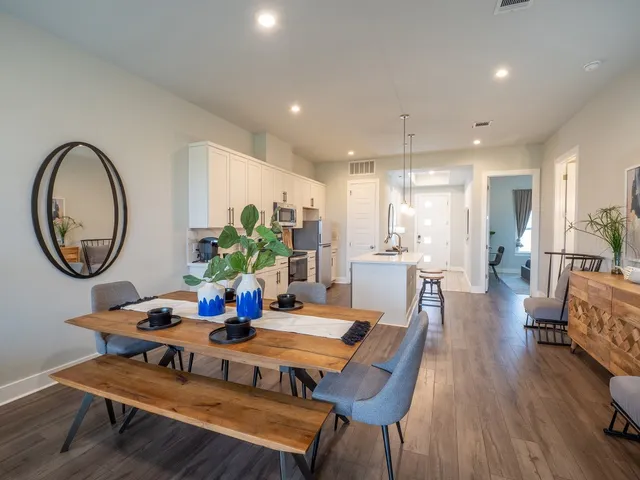a kitchen with stainless steel appliances granite countertop a sink a stove and a refrigerator