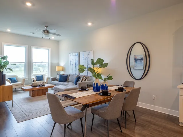 a kitchen with a sink a stove a refrigerator and white cabinets