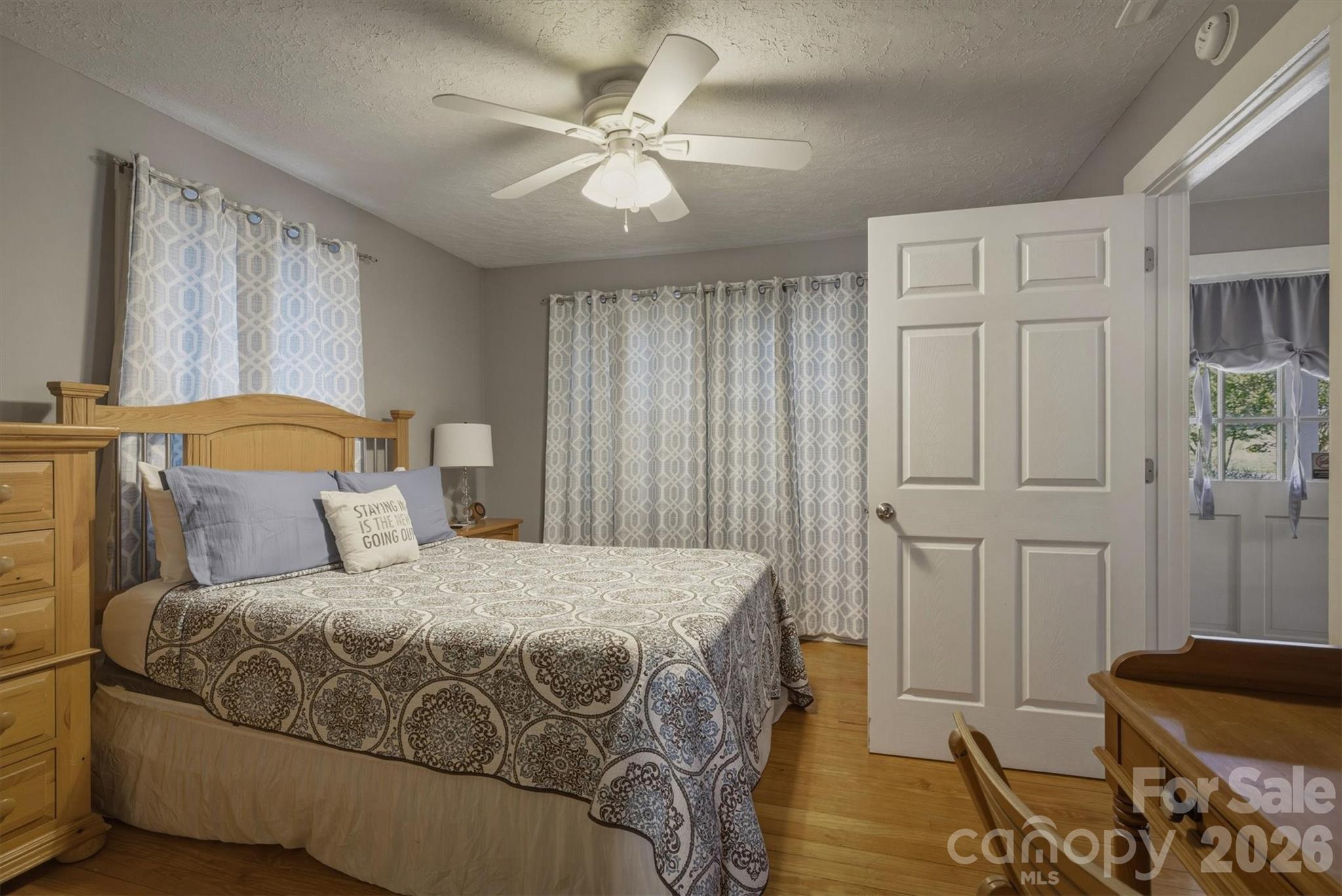 905 Carbon City Road Morganton, NC 28655 - Photo 22 of 29 a bedroom with a bed and wooden floor