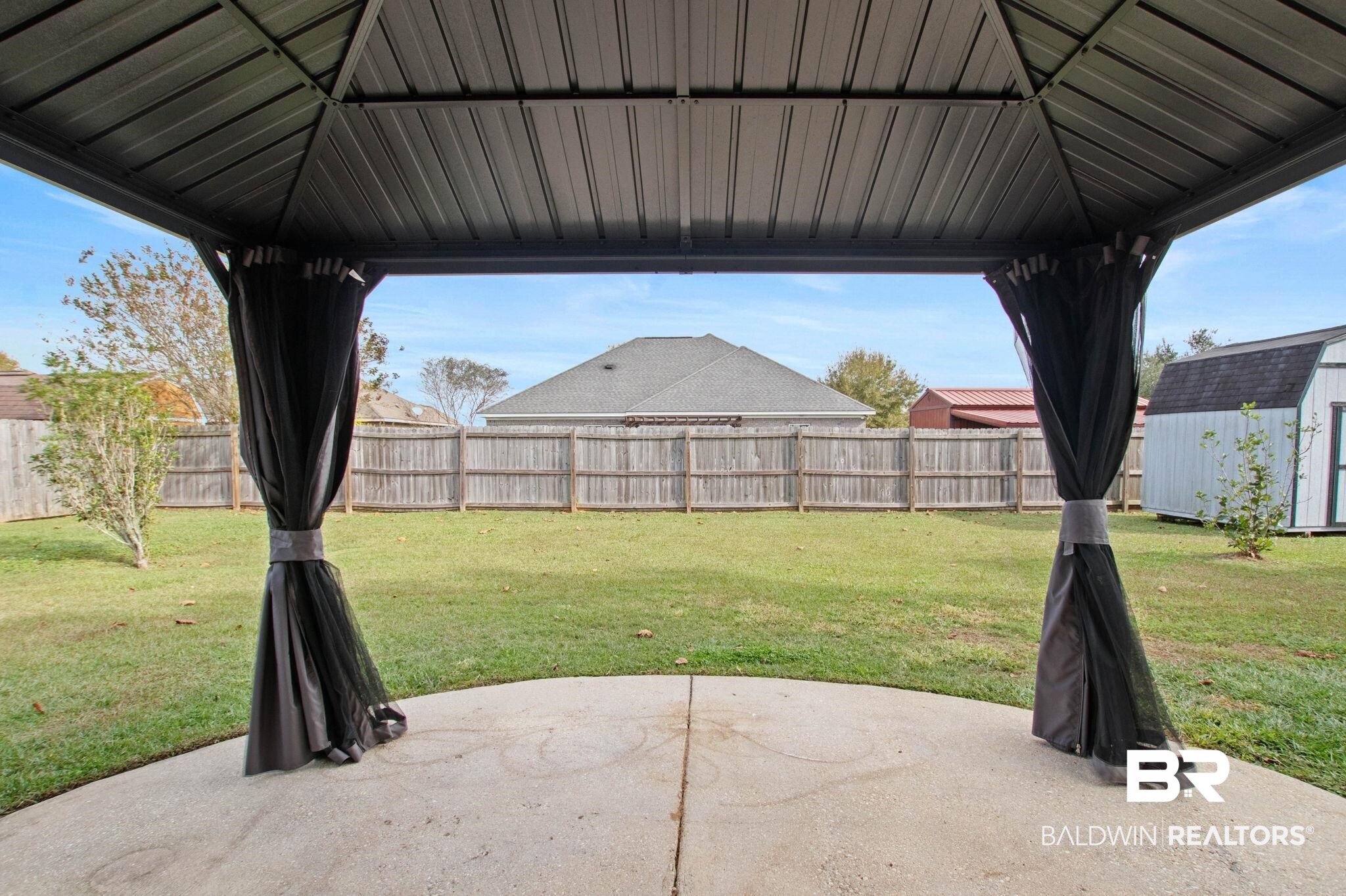 17376 Bankhead Boulevard Fairhope, AL 36532 - Photo 62 of 73 Fenced backyard featuring a patio area, a storage shed, and a gazebo