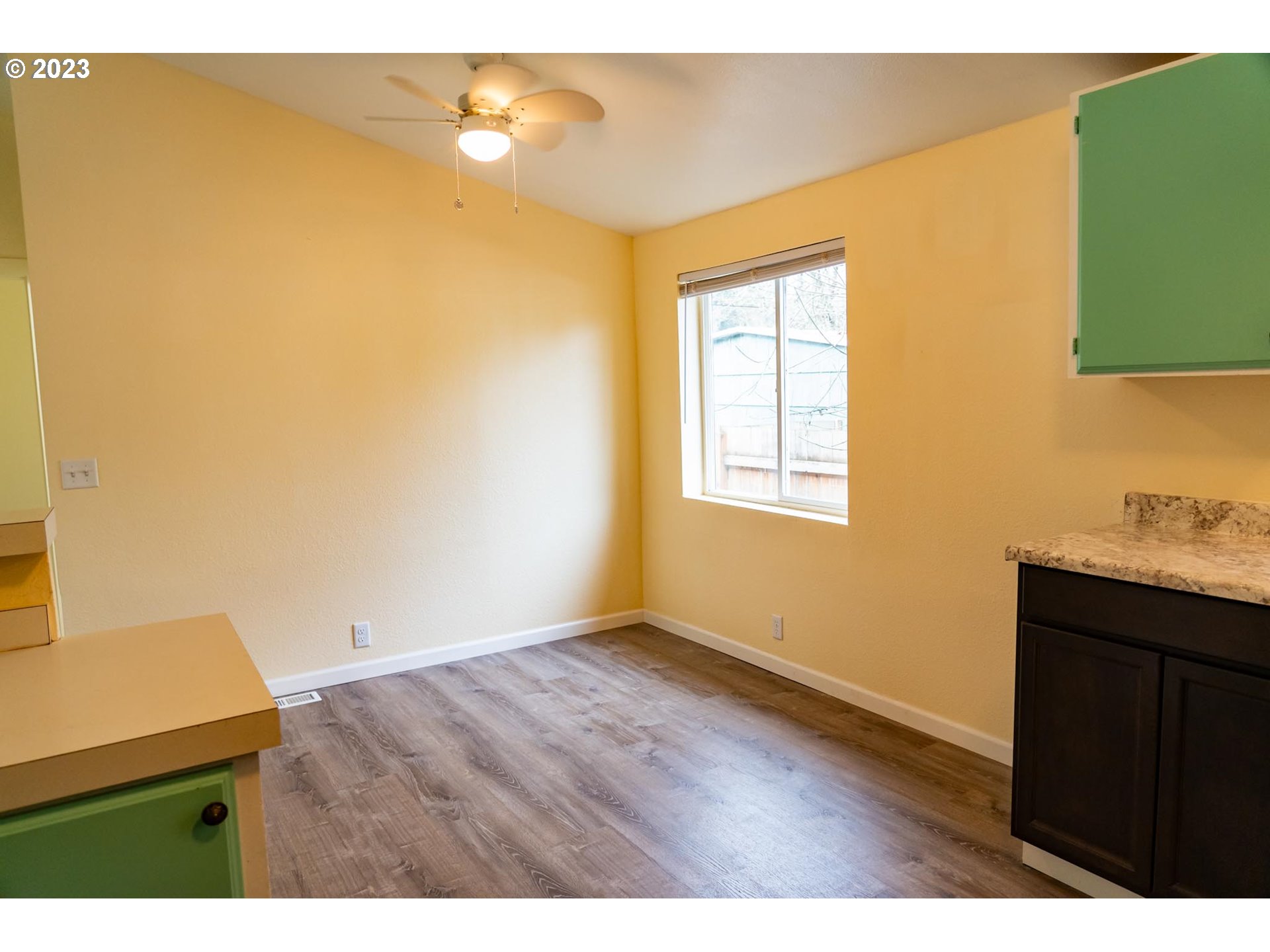 938 Water Street Springfield, OR 97477 - Photo 11 of 28 a view of an empty room with wooden floor and a window