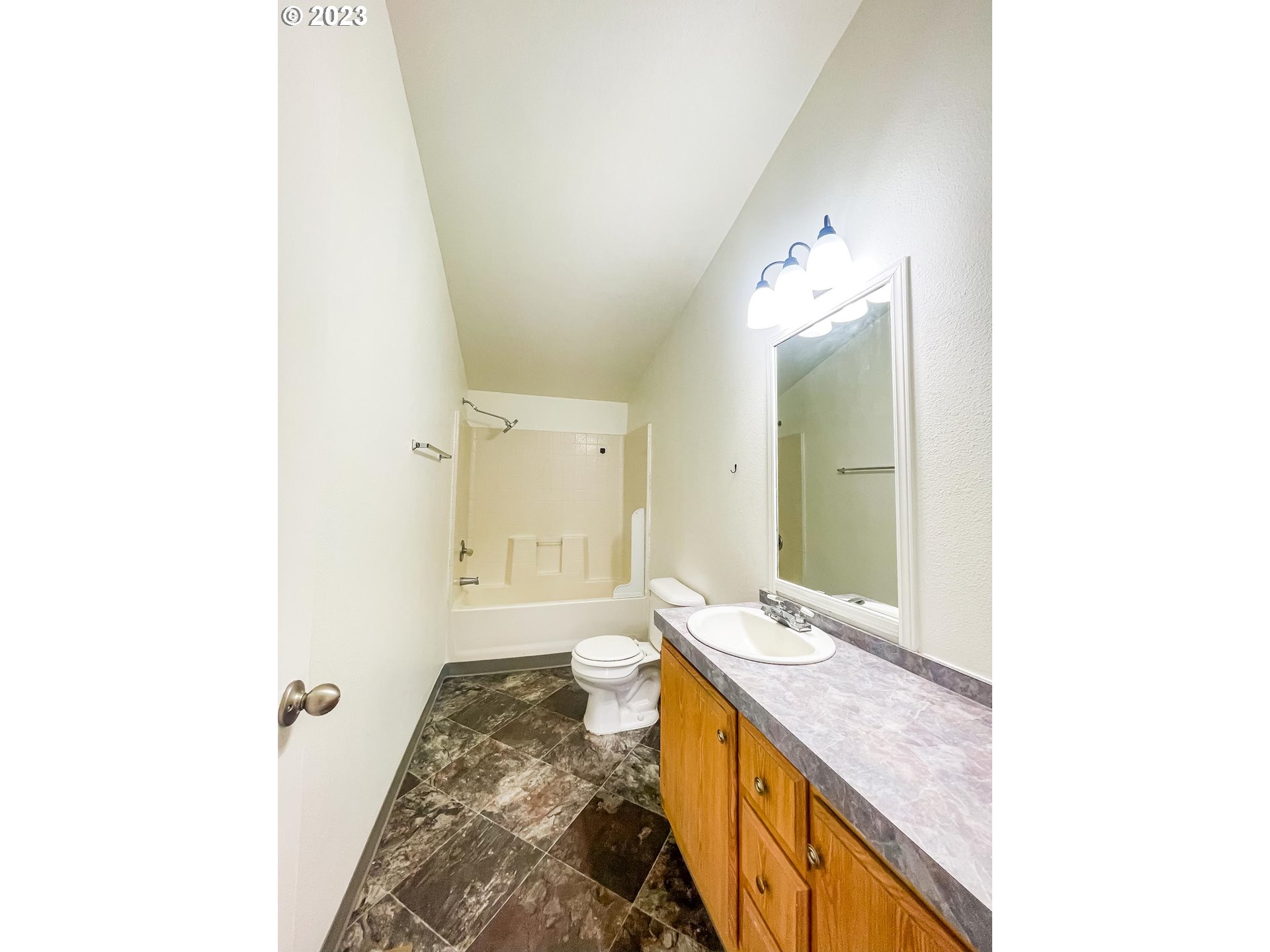 938 Water Street Springfield, OR 97477 - Photo 16 of 28 a spacious bathroom with a granite countertop sink and a mirror
