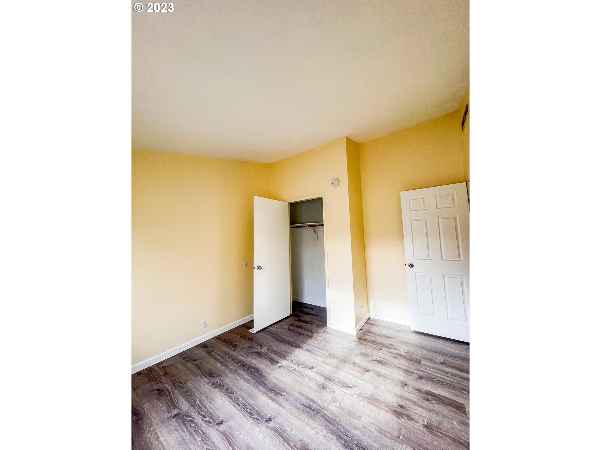 938 Water Street Springfield, OR 97477 - Photo 22 of 28 a view of a room with wooden floor and closet