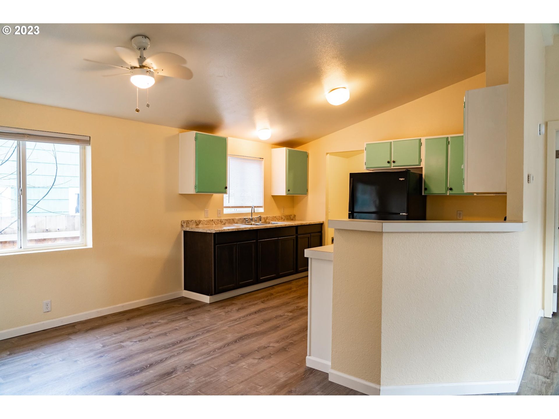 938 Water Street Springfield, OR 97477 - Photo 7 of 28 a kitchen with a refrigerator and a stove top oven