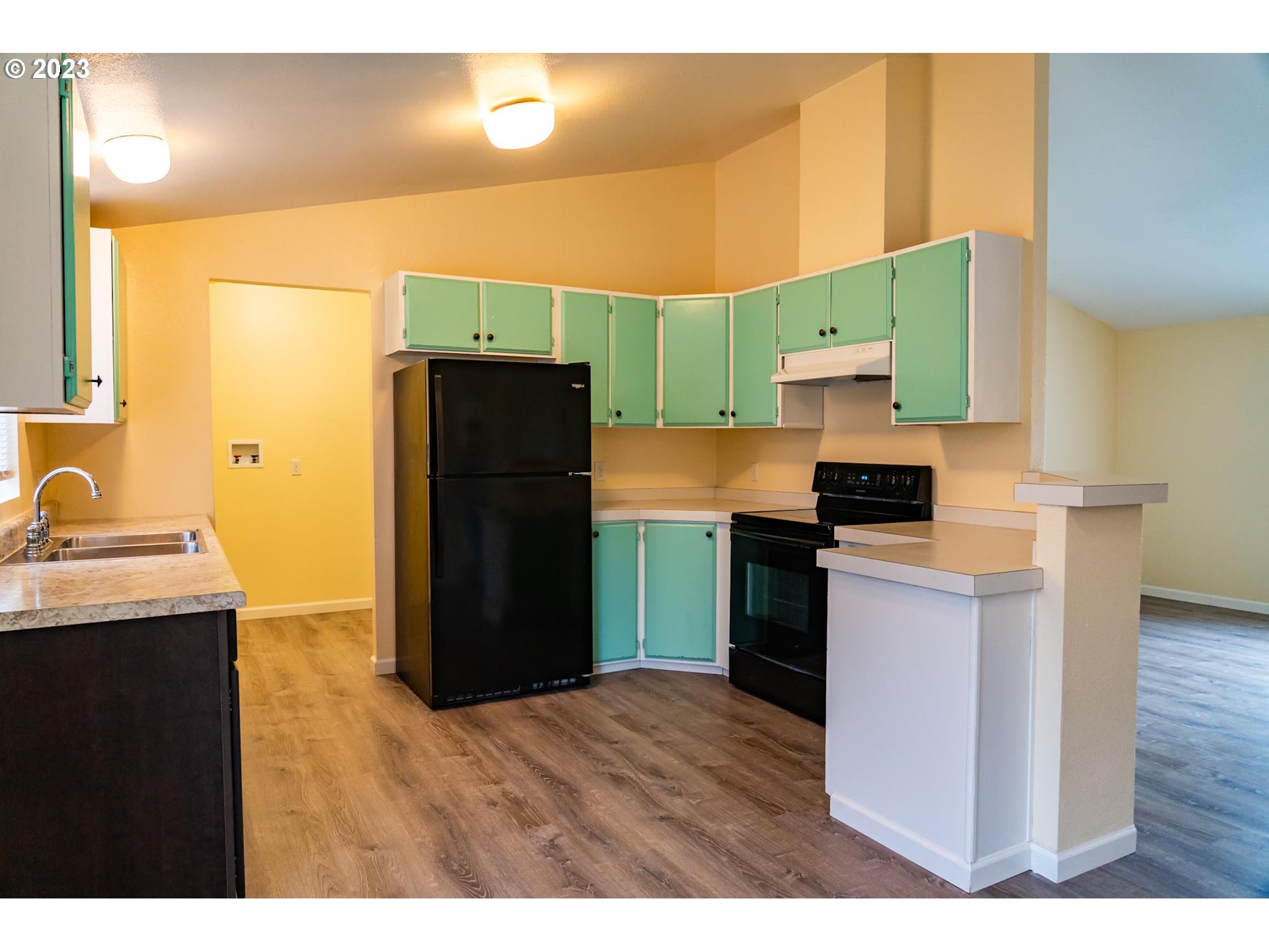 938 Water Street Springfield, OR 97477 - Photo 8 of 28 a kitchen with a refrigerator and a sink