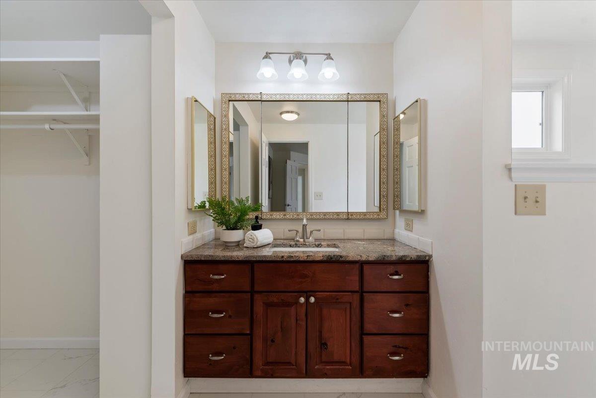 4297 Nystrom Way Boise, ID 83713 - Photo 18 of 50 Bathroom with vanity and a walk in closet