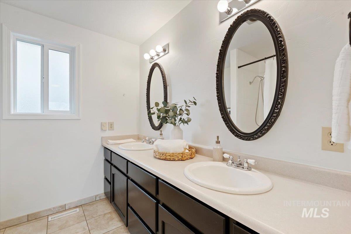 4297 Nystrom Way Boise, ID 83713 - Photo 24 of 50 Full upstairs bathroom featuring double vanity, light tile patterned floors, and a shower with curtain