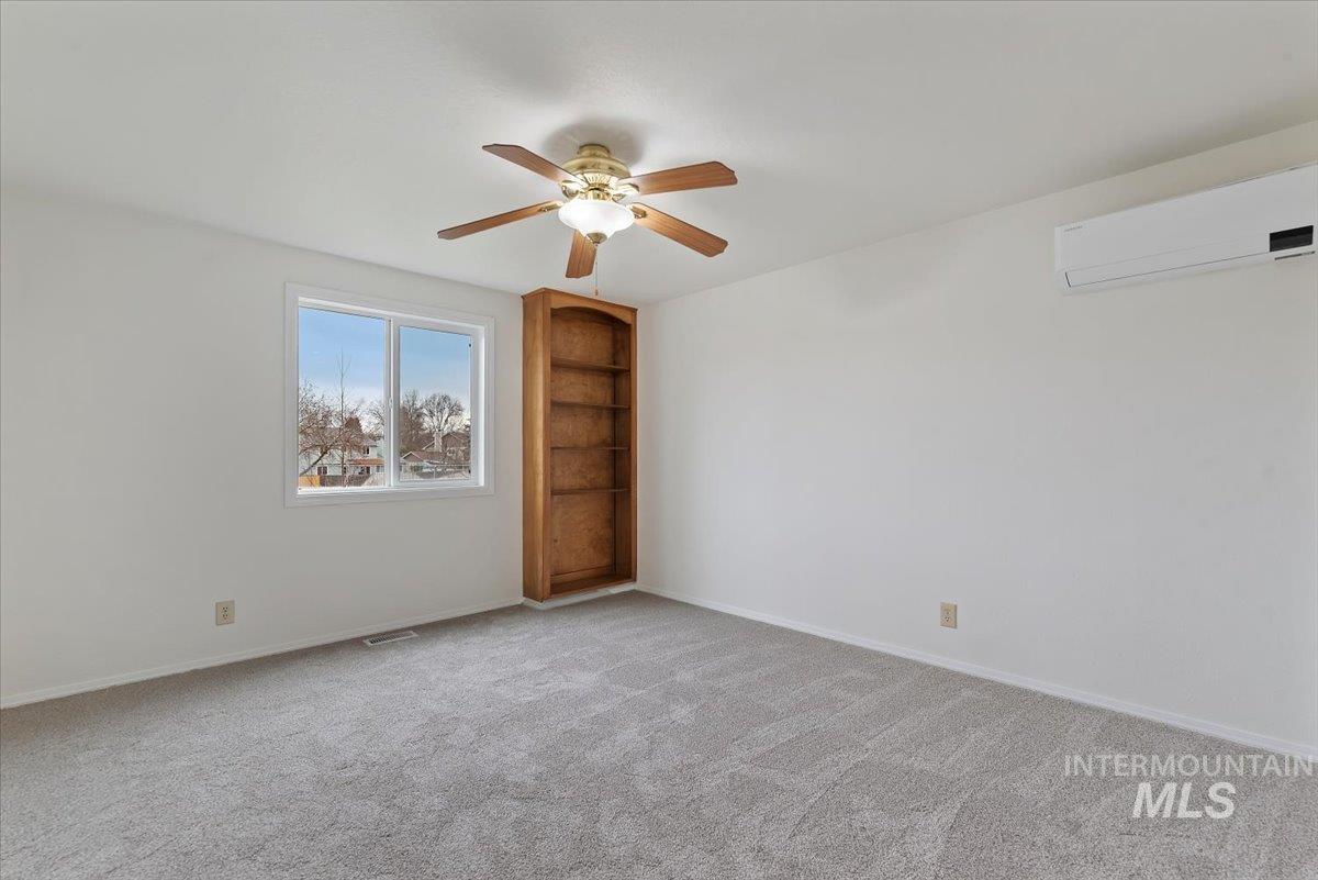 4297 Nystrom Way Boise, ID 83713 - Photo 25 of 50 Upstairs bedroom with light colored carpet, a ceiling fan, and built in features