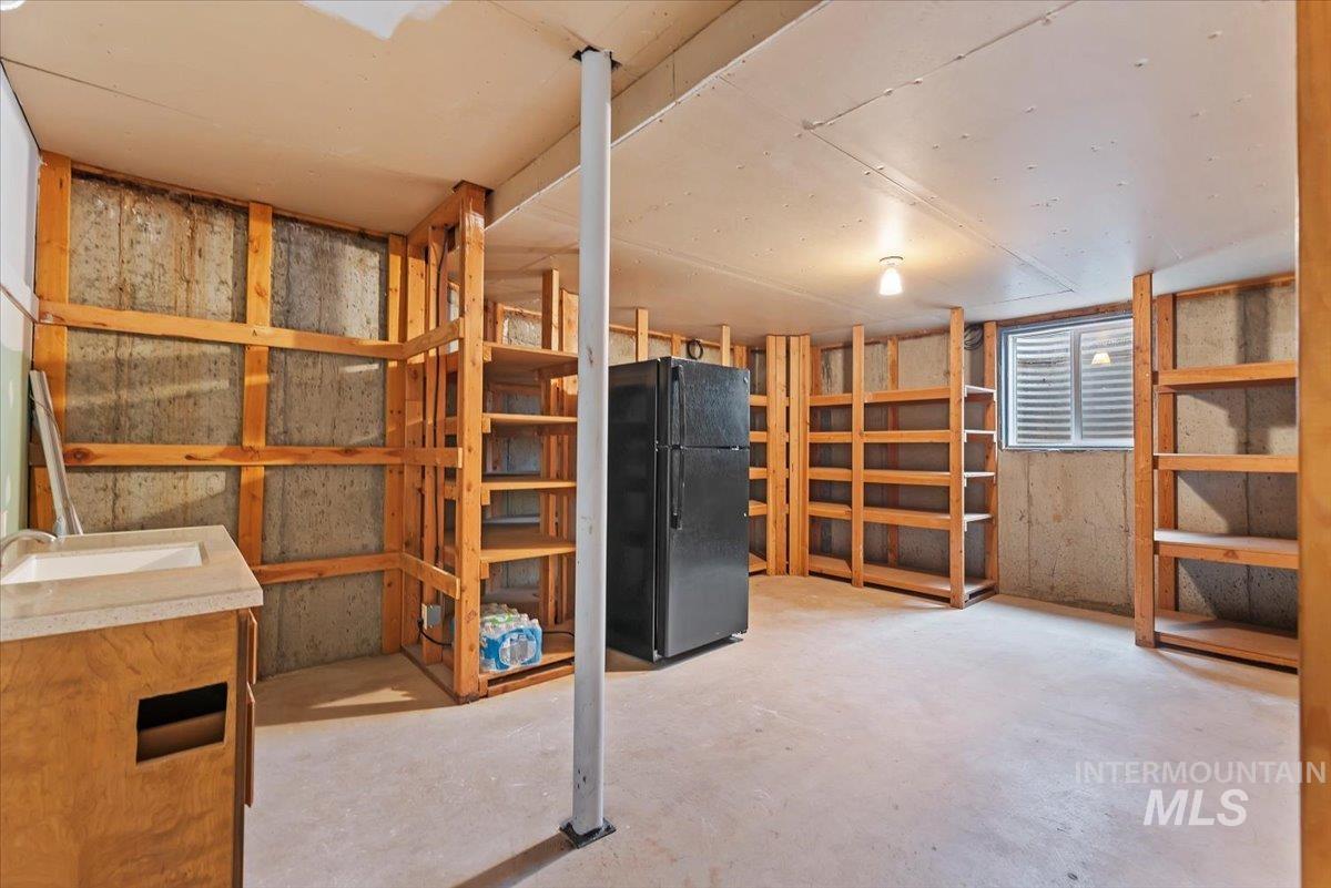 4297 Nystrom Way Boise, ID 83713 - Photo 32 of 50 Storage room in basement with built-in shelves and refrigerator