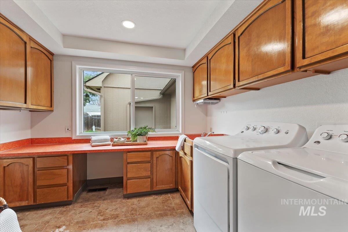4297 Nystrom Way Boise, ID 83713 - Photo 33 of 50 Laundry room with washer and dryer, tons of cabinet space, recessed lighting, and a raised ceiling. (Not shown, fridge next to the washer and dryer, and laundry chute access).