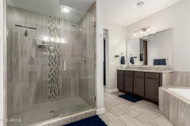 a bathroom with a tub sink and mirror