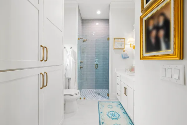 a bathroom with a sink a toilet and shower