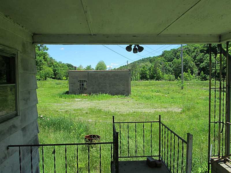 1112 Upper Mateer Road Vandergrift, PA 15690 - Photo 3 of 21 Patio/Deck. View of the garage from the rear covered concrete patio. Patio in great shape.
