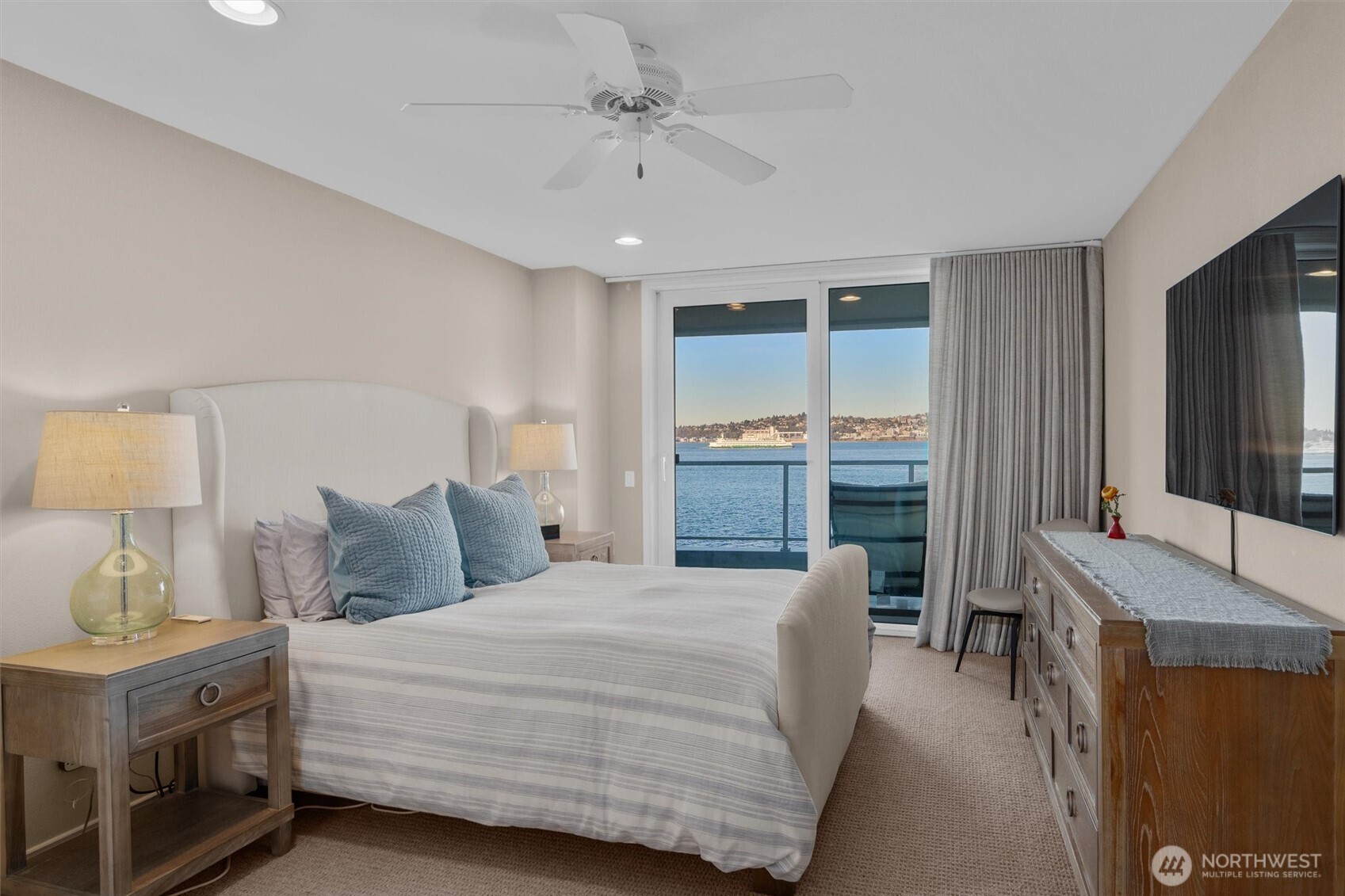 1005 Harbor Avenue Southwest, Unit 400 Seattle, WA 98116 - Photo 13 of 39 a bedroom with a large bed and a chandelier