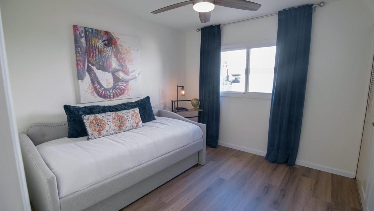 8307 East Arlington Road Scottsdale, AZ 85250 - Photo 18 of 25 a bedroom with a large bed and a chandelier