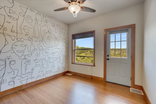 wooden floor in an empty room with a window