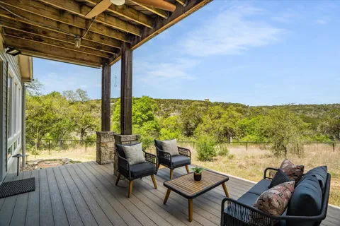 a balcony with furniture and wooden floor