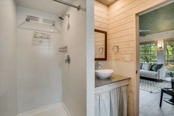 a bathroom with a sink toilet and shower