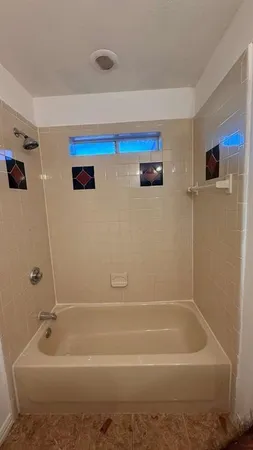 a bathroom with a tub and a shower