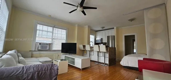 a living room with furniture wooden floor and a flat screen tv