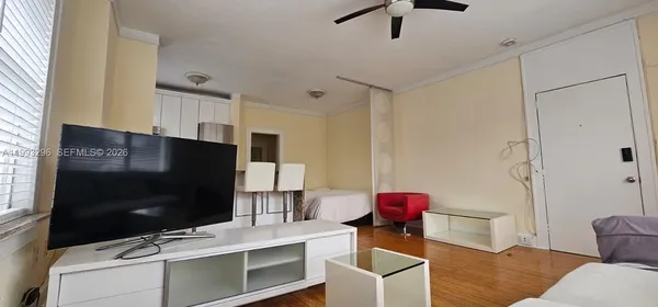 a spacious bedroom with a bed and a wooden floor