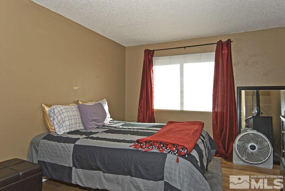2095 Highview Court, Unit 7 Reno, NV 89512 - Photo 15 of 24 a bedroom with a bed and window