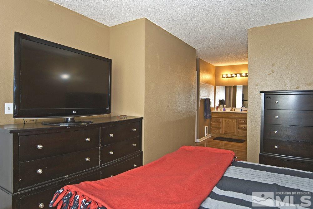 2095 Highview Court, Unit 7 Reno, NV 89512 - Photo 16 of 24 a bedroom with a bed and a flat screen tv