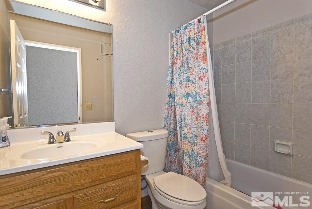 2095 Highview Court, Unit 7 Reno, NV 89512 - Photo 20 of 24 a bathroom with a sink a toilet and shower