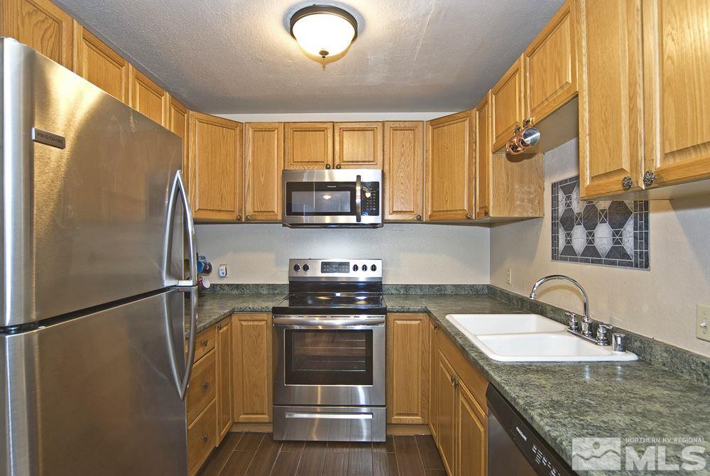 2095 Highview Court, Unit 7 Reno, NV 89512 - Photo 5 of 24 a kitchen with a sink a refrigerator and a stove