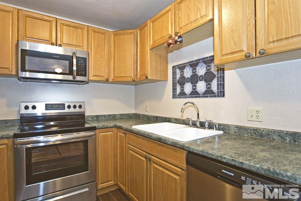 2095 Highview Court, Unit 7 Reno, NV 89512 - Photo 6 of 24 a kitchen with stainless steel appliances granite countertop a sink and a stove