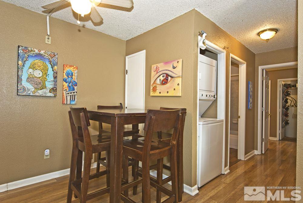2095 Highview Court, Unit 7 Reno, NV 89512 - Photo 8 of 24 a view of a dining room with furniture wooden floor and a chandelier