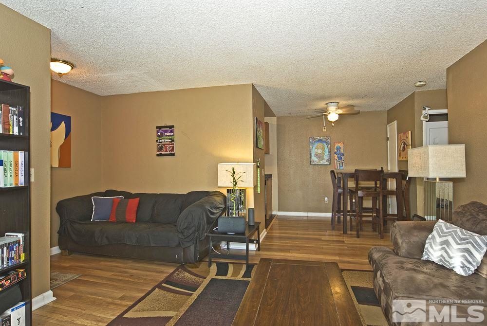 2095 Highview Court, Unit 7 Reno, NV 89512 - Photo 10 of 24 a living room with furniture and a dining table with wooden floor