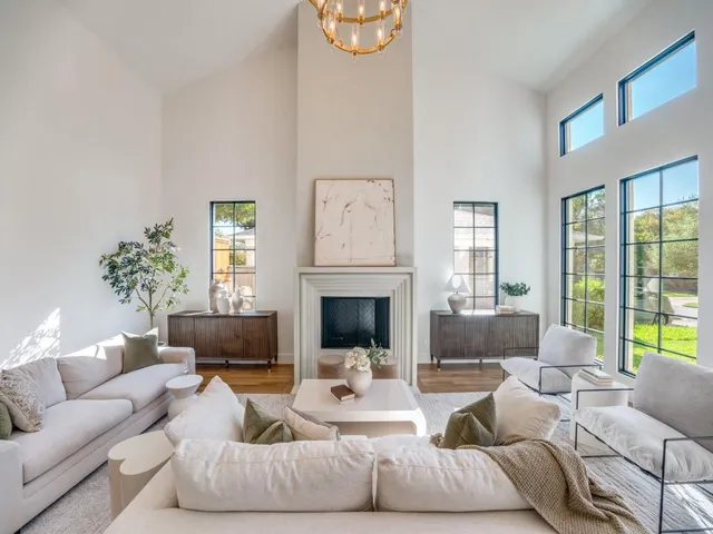 a living room with furniture fireplace and window