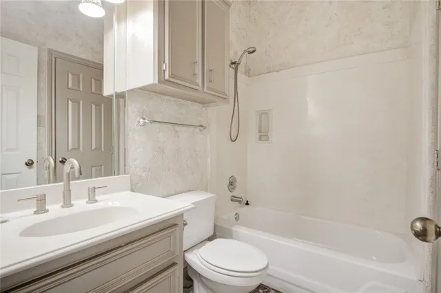 a view of a big room with windows and chandelier fan