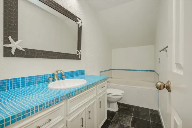 a view of a house with a big yard and potted plants