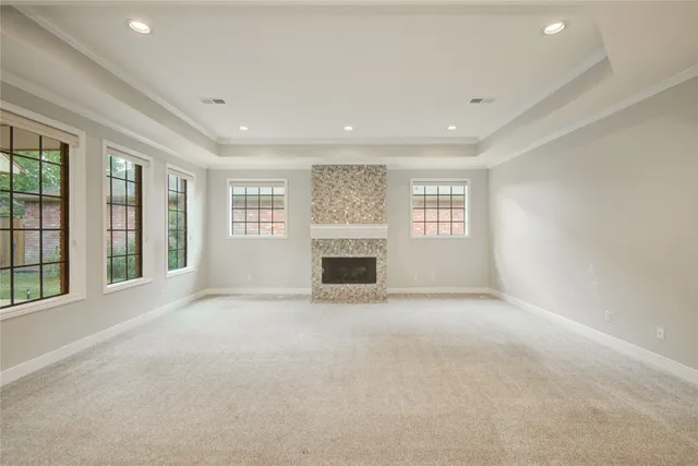 a view of an empty room with a fireplace and a large window