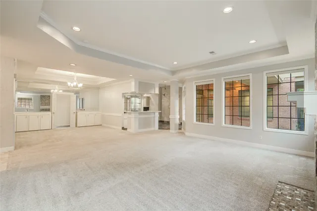 a view of a hallway with white cabinets