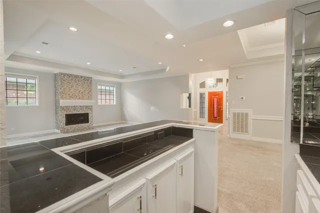 a view of a hallway with stairs and a chandelier