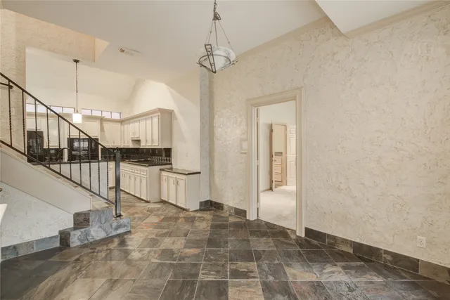 a view of a big room with wooden floor and windows