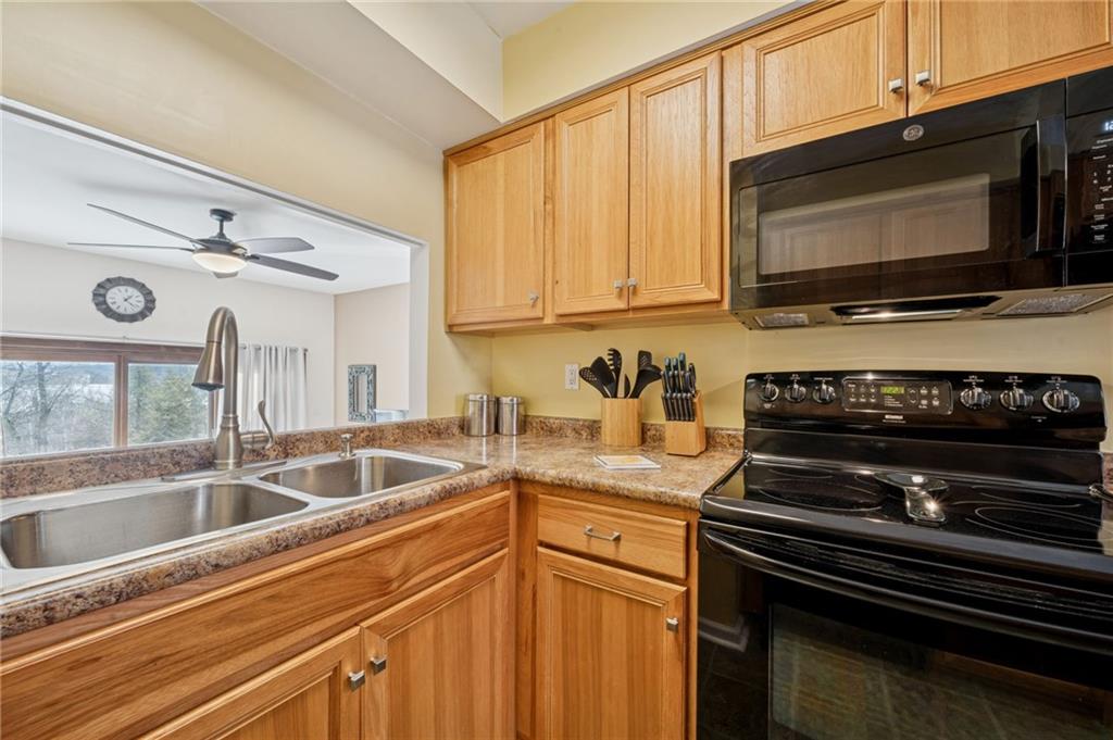 117 Community Court Pittsburgh, PA 15205 - Photo 11 of 34 a kitchen with a sink stove and microwave