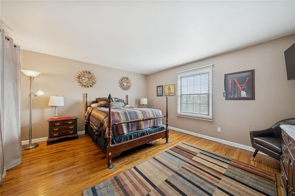 117 Community Court Pittsburgh, PA 15205 - Photo 18 of 34 a bedroom with a bed and wooden floor