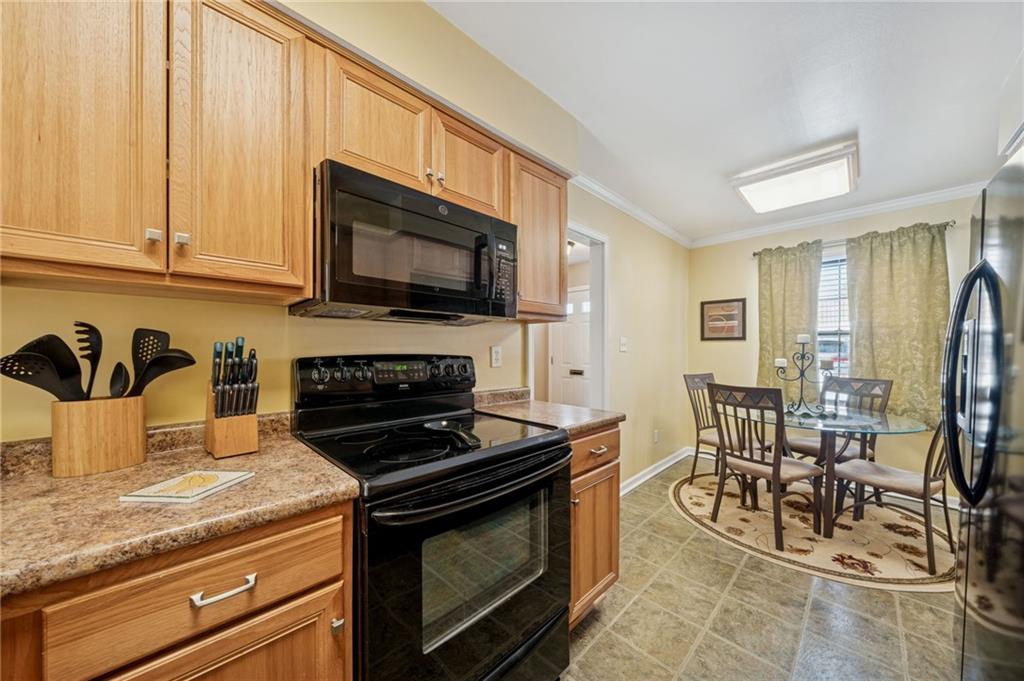 117 Community Court Pittsburgh, PA 15205 - Photo 9 of 34 a kitchen with stainless steel appliances granite countertop a stove a sink a microwave and a refrigerator
