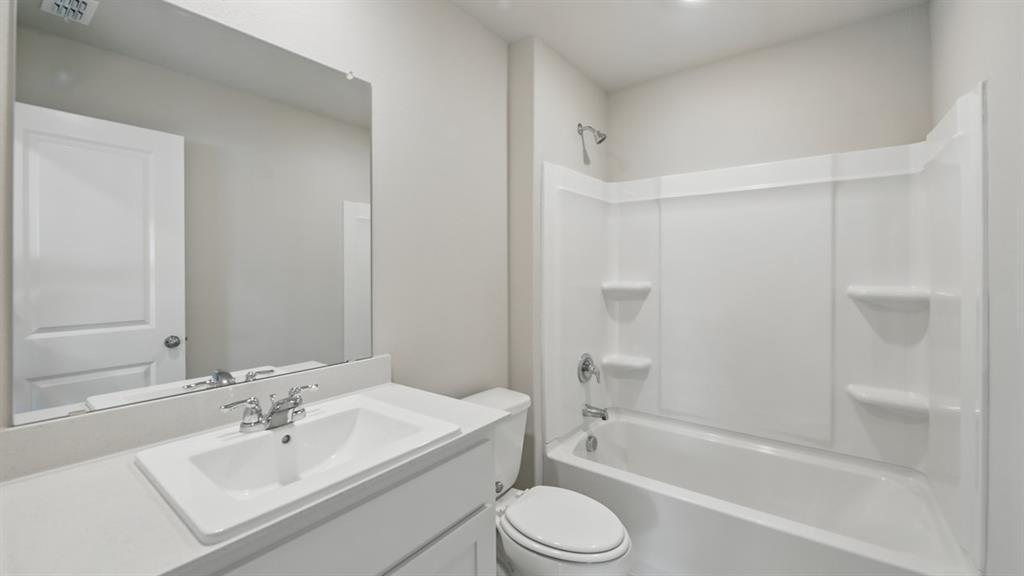 172 Mojave Road Boyd, TX 76023 - Photo 32 of 40 a bathroom with a bathtub shower sink vanity mirror and toilet