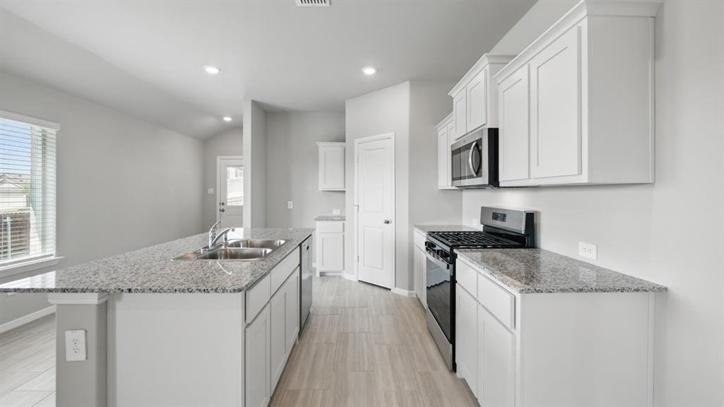 172 Mojave Road Boyd, TX 76023 - Photo 2 of 40 a kitchen with stainless steel appliances granite countertop a sink stove and cabinets